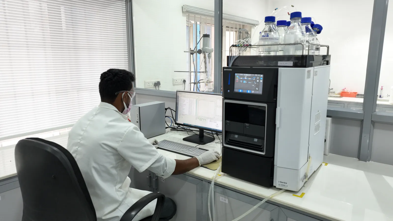 An analyst at the high-performance liquid chromatography system